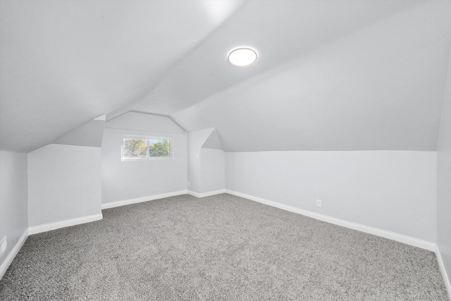 bonus room featuring carpet flooring and vaulted ceiling