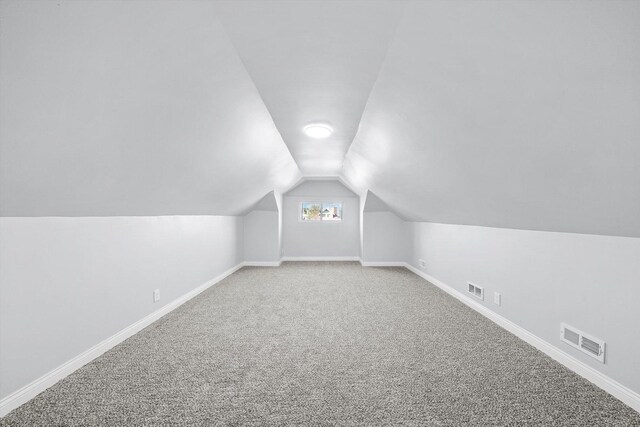 bonus room featuring carpet and vaulted ceiling