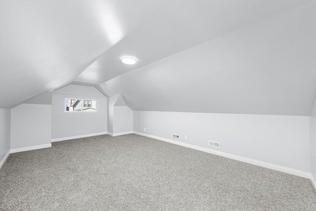 bonus room with carpet flooring and lofted ceiling