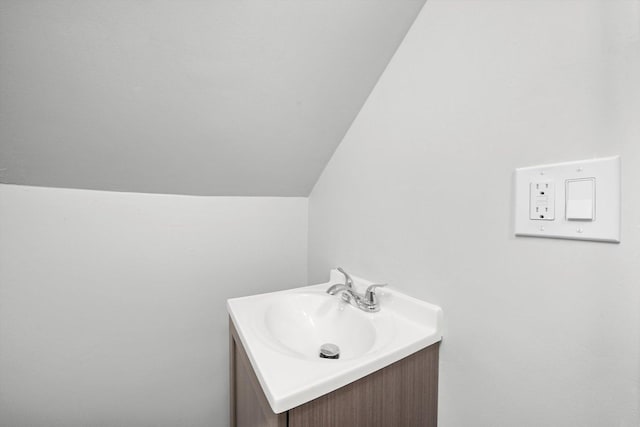 bathroom with vanity and vaulted ceiling