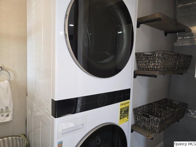 laundry area with stacked washer and clothes dryer