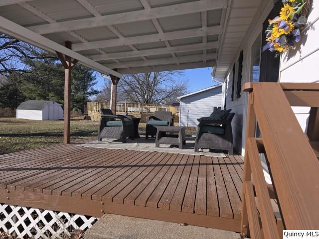 wooden deck featuring a storage shed