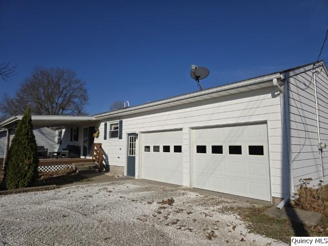 exterior space featuring a garage and covered porch