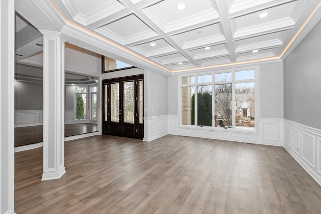 entryway featuring french doors, decorative columns, coffered ceiling, ornamental molding, and beam ceiling