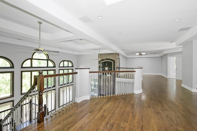 hallway with dark wood-type flooring and a healthy amount of sunlight