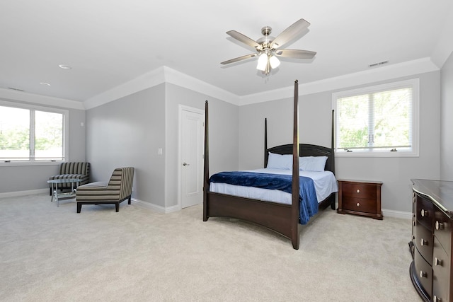 carpeted bedroom with ornamental molding and ceiling fan