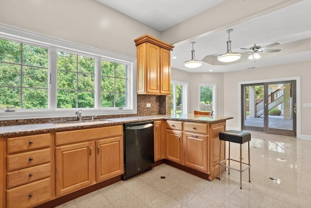 kitchen featuring sink, dishwasher, kitchen peninsula, ceiling fan, and backsplash