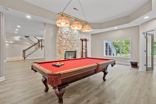 game room with a fireplace, billiards, and light wood-type flooring