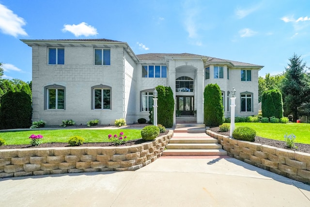 mediterranean / spanish house featuring a front lawn