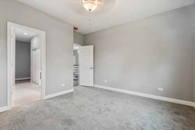 unfurnished bedroom with light carpet and ceiling fan