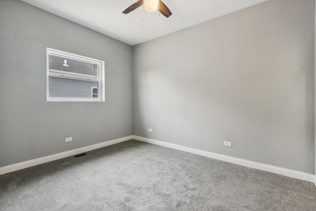 carpeted spare room featuring ceiling fan