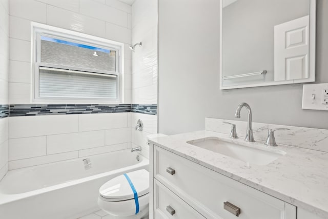 full bathroom featuring vanity, toilet, and tiled shower / bath combo