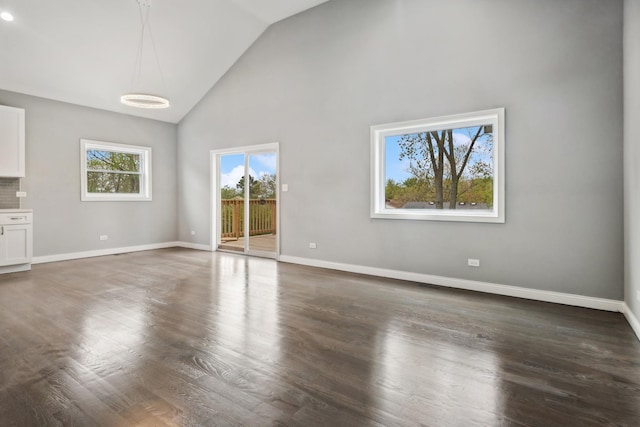 unfurnished living room featuring dark hardwood / wood-style flooring and high vaulted ceiling