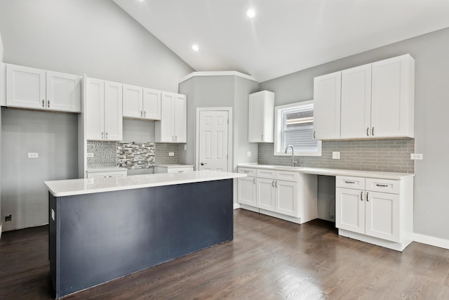 kitchen featuring a kitchen island, white cabinetry, and sink