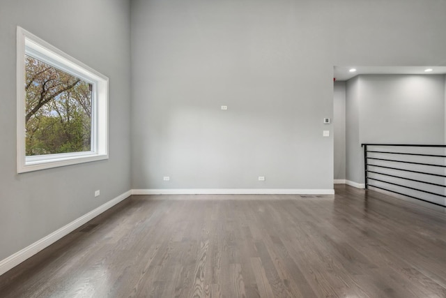 spare room with dark hardwood / wood-style floors