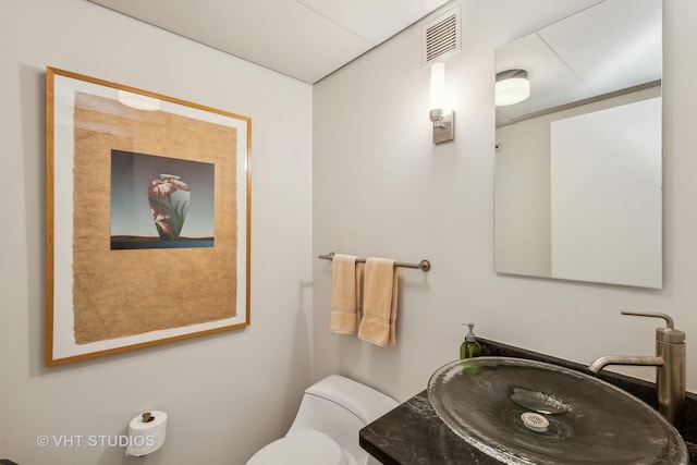 bathroom with vanity and toilet