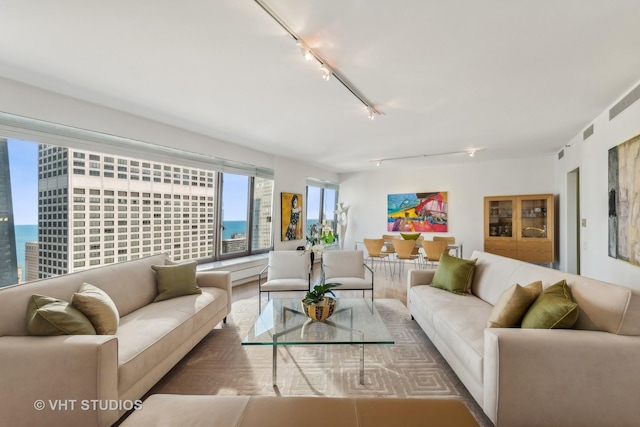 living room featuring a water view and track lighting