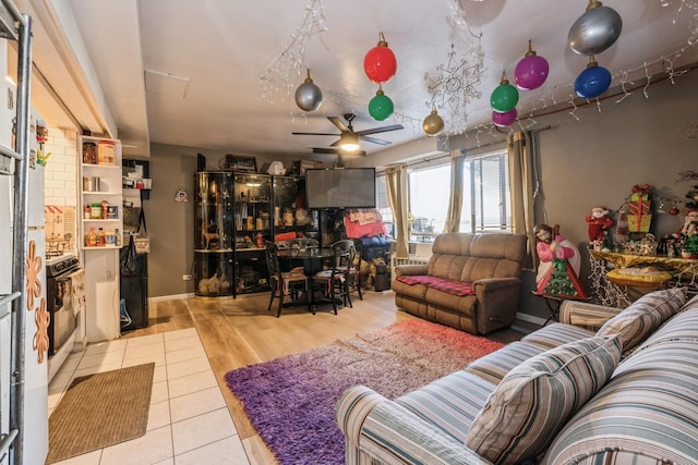 living room with light wood-type flooring and ceiling fan