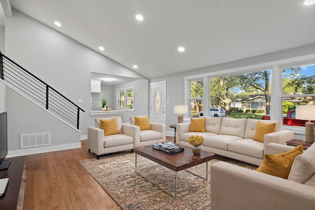 living room featuring hardwood / wood-style flooring and vaulted ceiling