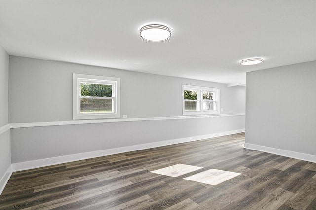 unfurnished room featuring dark hardwood / wood-style floors and a healthy amount of sunlight