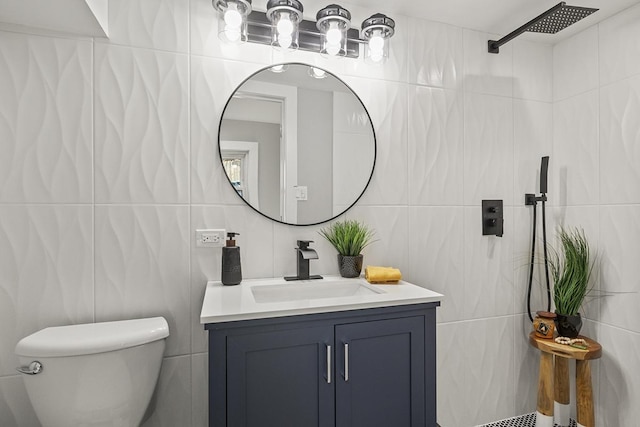 bathroom featuring walk in shower, vanity, toilet, and tile walls