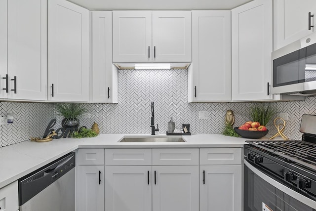 kitchen with decorative backsplash, appliances with stainless steel finishes, and white cabinetry