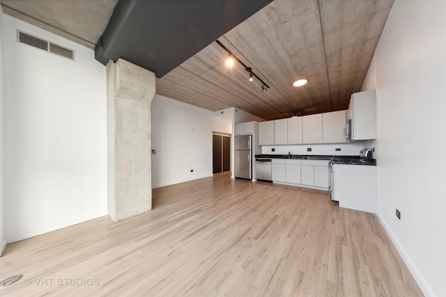 kitchen with appliances with stainless steel finishes, light wood-type flooring, rail lighting, and white cabinetry