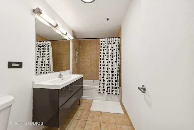 full bathroom featuring tile patterned flooring, vanity, toilet, and shower / bath combo with shower curtain