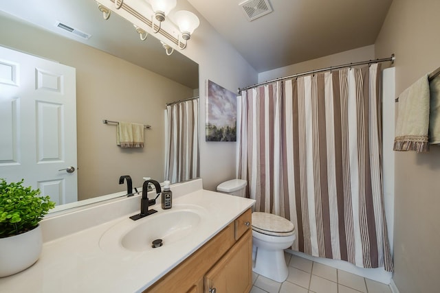 bathroom with an inviting chandelier, toilet, tile patterned floors, and vanity