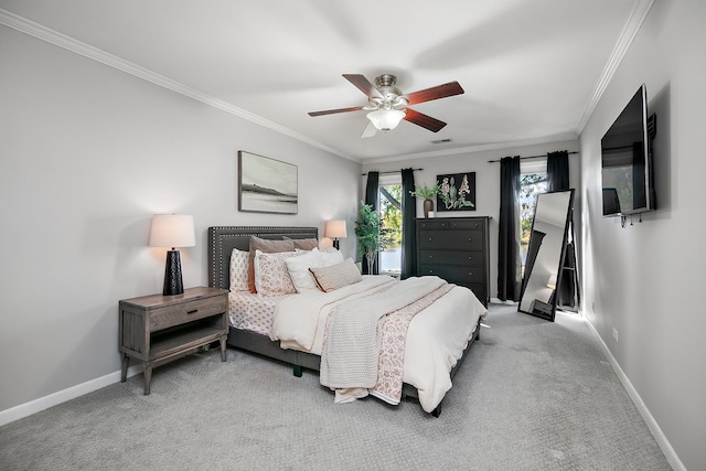 carpeted bedroom featuring ceiling fan and ornamental molding