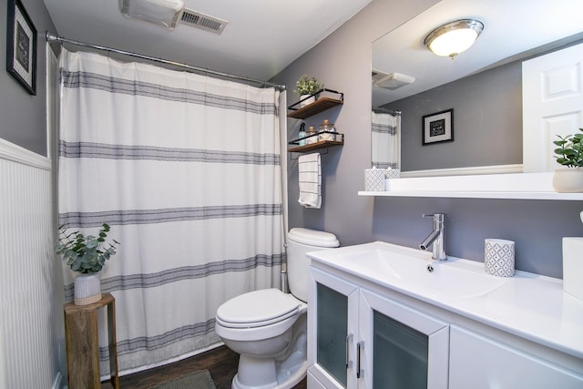 bathroom with wood-type flooring, vanity, and toilet