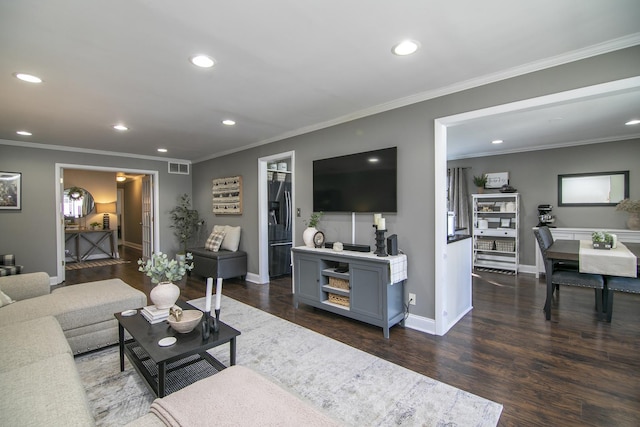 living room featuring dark wood-type flooring and ornamental molding