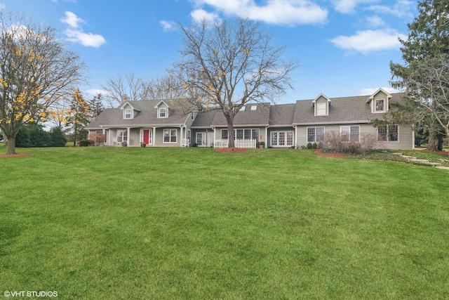 new england style home featuring a front lawn