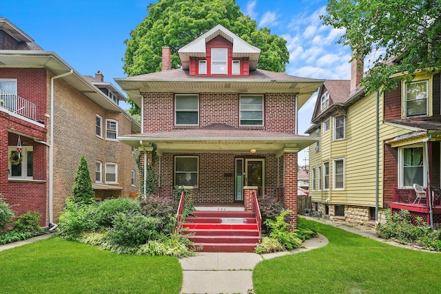 front of property with covered porch and a front lawn