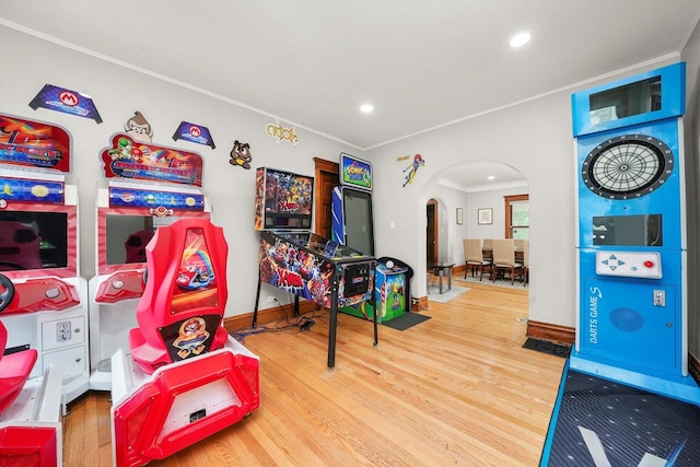 recreation room featuring hardwood / wood-style floors and crown molding