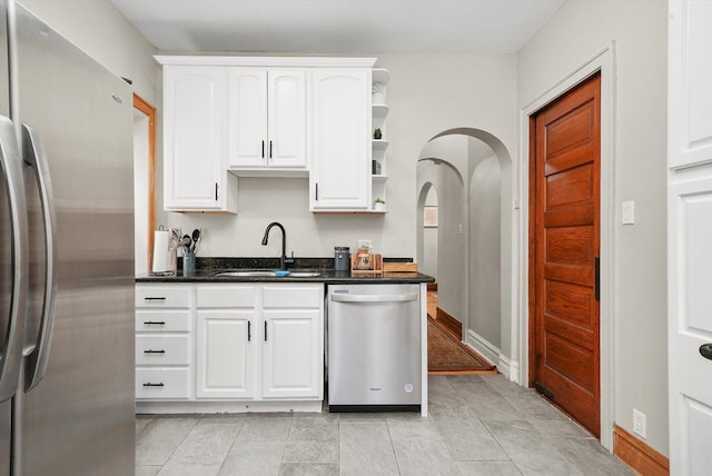 kitchen featuring white cabinetry, sink, and appliances with stainless steel finishes