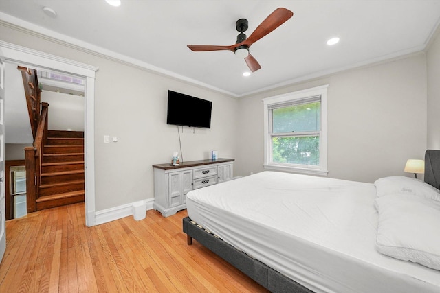 bedroom featuring ceiling fan, light hardwood / wood-style flooring, and ornamental molding