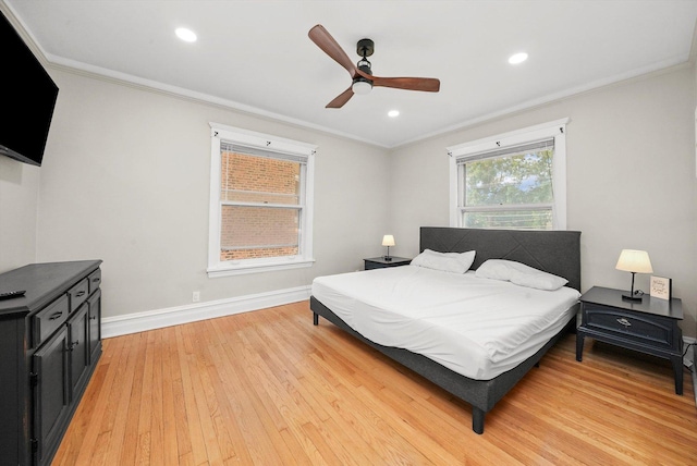 bedroom with ceiling fan, ornamental molding, and light hardwood / wood-style flooring