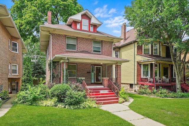 view of front of property featuring covered porch and a front yard