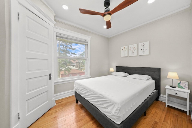 bedroom featuring ceiling fan, wood-type flooring, and crown molding