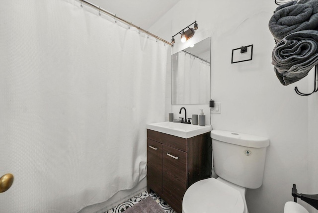 bathroom with vanity, toilet, and walk in shower