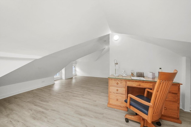 home office featuring vaulted ceiling and light wood-type flooring