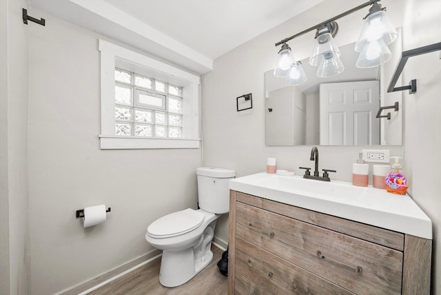 bathroom with vanity, wood-type flooring, and toilet