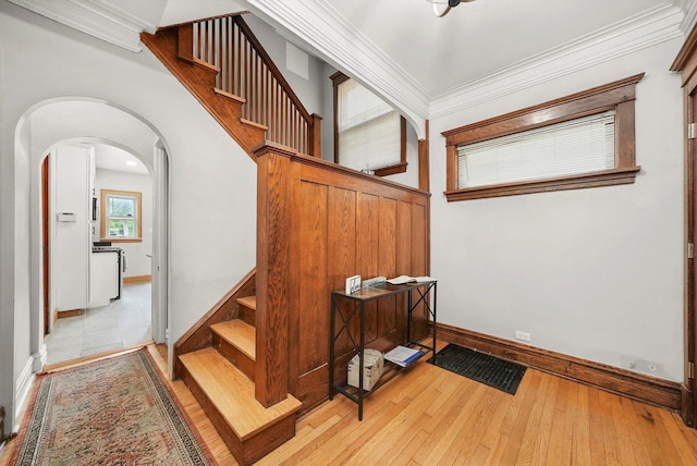 staircase featuring hardwood / wood-style flooring and ornamental molding