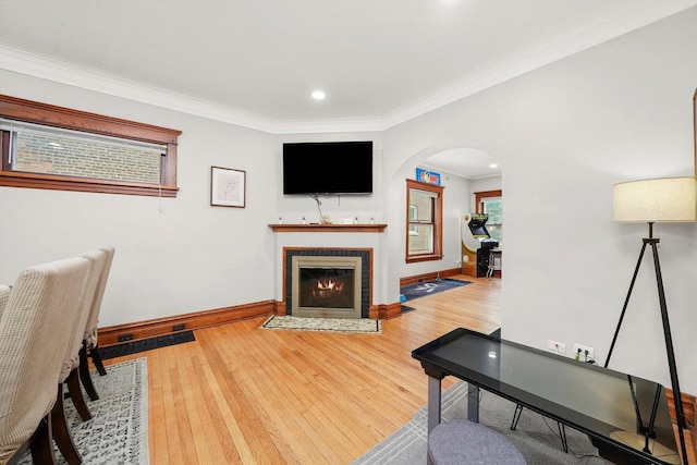 living room with hardwood / wood-style floors and ornamental molding