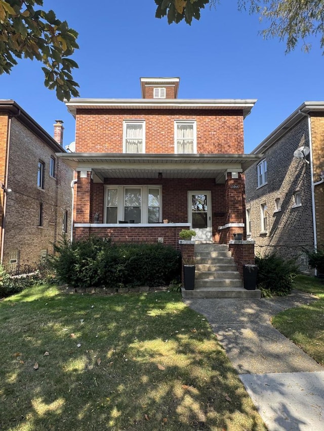 view of front of house featuring covered porch and a front lawn