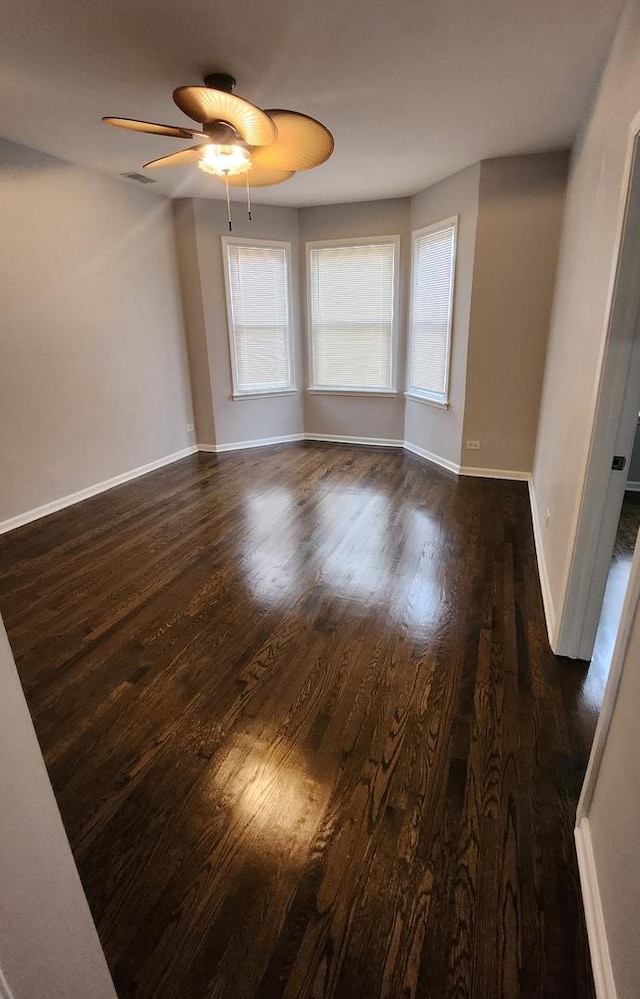 empty room featuring dark hardwood / wood-style floors and ceiling fan