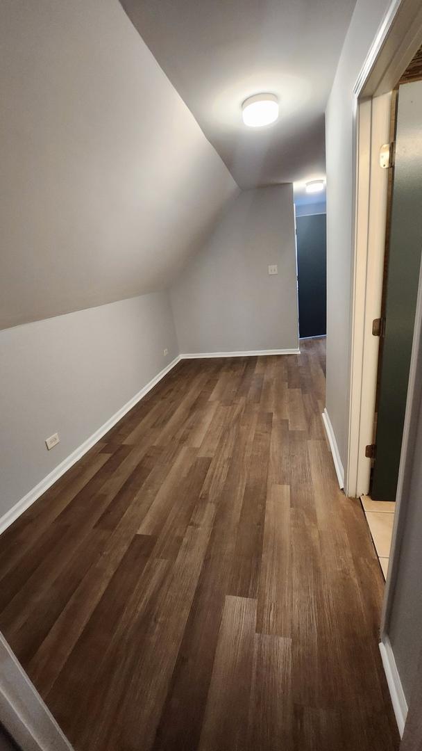 bonus room with wood-type flooring and lofted ceiling