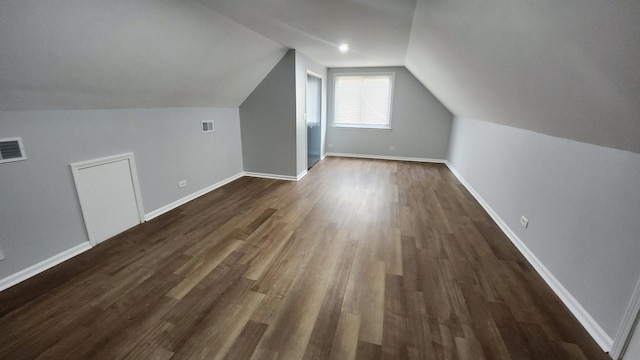 bonus room with dark hardwood / wood-style floors and lofted ceiling