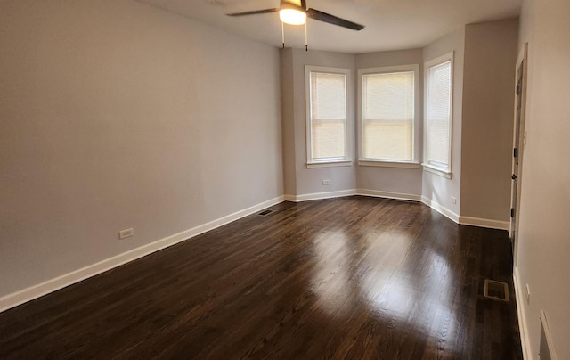 unfurnished room with dark hardwood / wood-style floors and ceiling fan